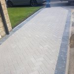 Natural block paved driveway with a charcoal coloured border